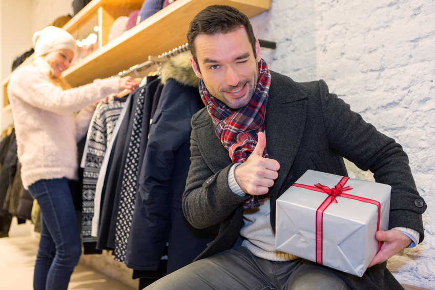 Young attrative man preparing gift surprise